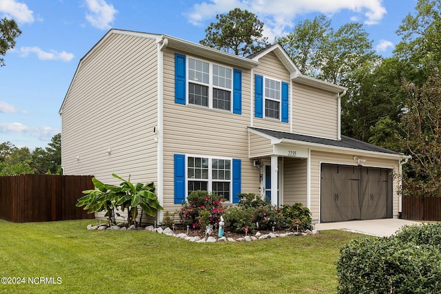 view of front of property featuring a front lawn and a garage