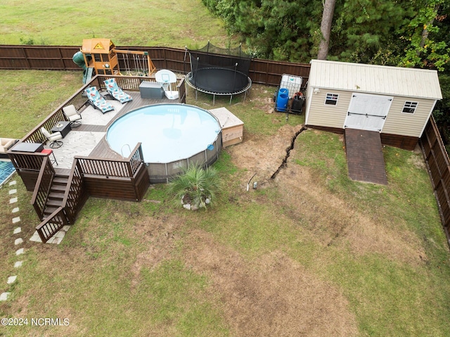 exterior space featuring a trampoline and a pool side deck