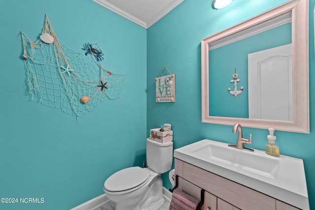 bathroom featuring vanity, crown molding, and toilet