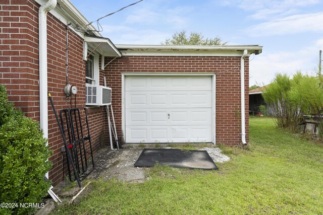 garage featuring a lawn