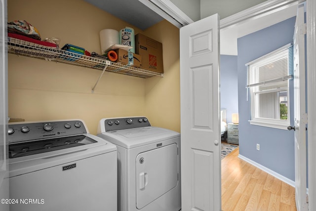 laundry area featuring light wood-type flooring and independent washer and dryer