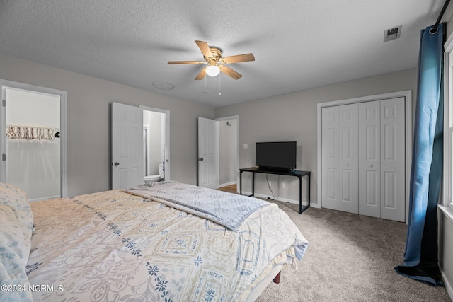 carpeted bedroom featuring ceiling fan and a textured ceiling