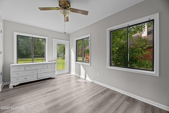 unfurnished bedroom with multiple windows, light wood-type flooring, and ceiling fan