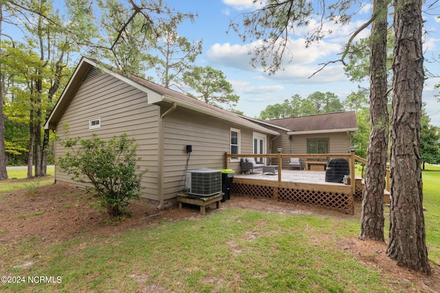 back of property featuring a lawn, central AC, and a deck