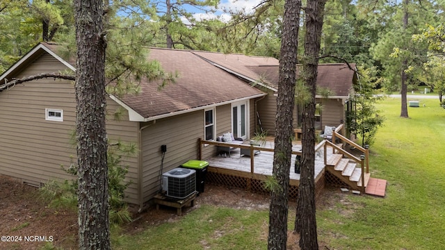 exterior space featuring a lawn, cooling unit, and a wooden deck