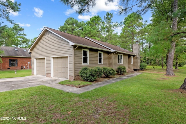 single story home with a garage and a front lawn