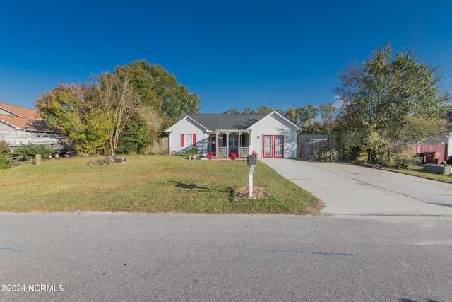 view of front of property with a front yard and french doors