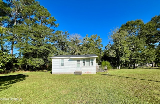 back of property with a lawn