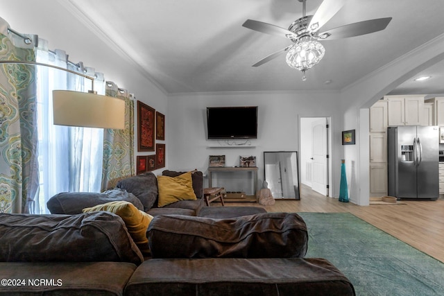 living room with ceiling fan, light hardwood / wood-style flooring, and ornamental molding