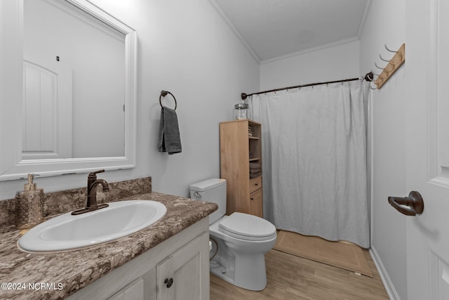 bathroom featuring toilet, vanity, wood-type flooring, and ornamental molding