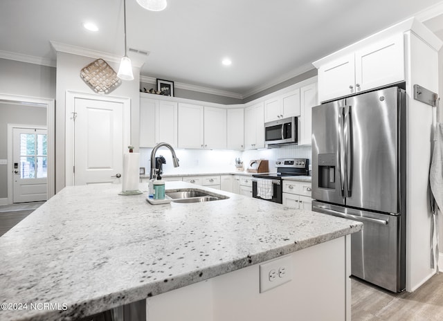 kitchen with stainless steel appliances, white cabinetry, light hardwood / wood-style floors, and sink