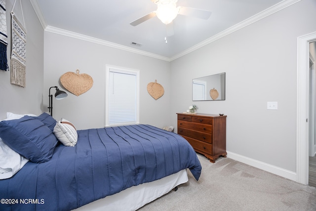 carpeted bedroom with ceiling fan and ornamental molding