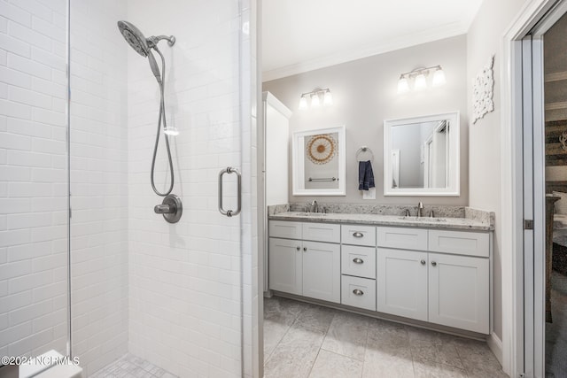 bathroom with vanity, a shower with shower door, and crown molding