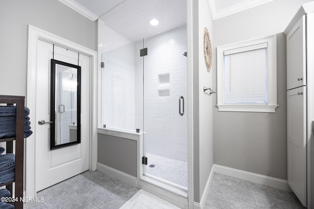 bathroom with crown molding, tile patterned flooring, and a shower with door