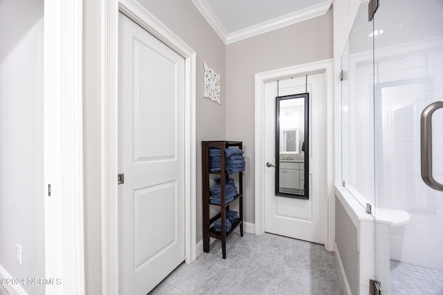 interior space with tile patterned flooring, an enclosed shower, and crown molding