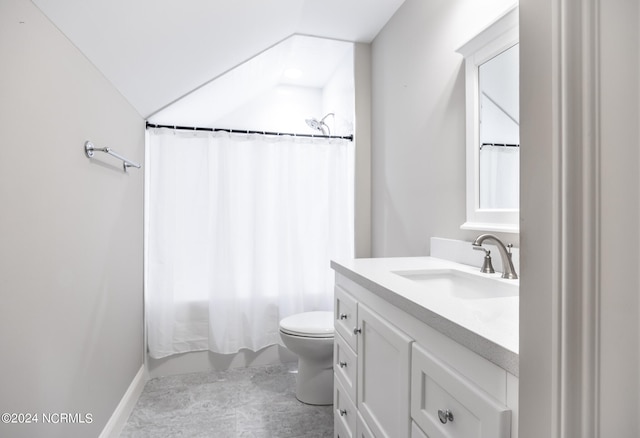 bathroom with tile patterned flooring, vaulted ceiling, vanity, and toilet