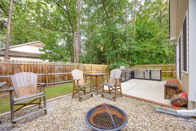 view of patio with a fire pit