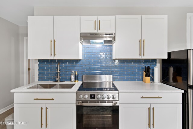 kitchen with white cabinets, a kitchen bar, stainless steel appliances, and sink