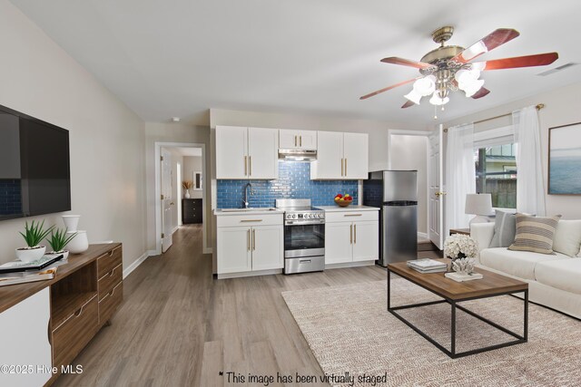 kitchen with dishwasher, a wealth of natural light, and light hardwood / wood-style flooring