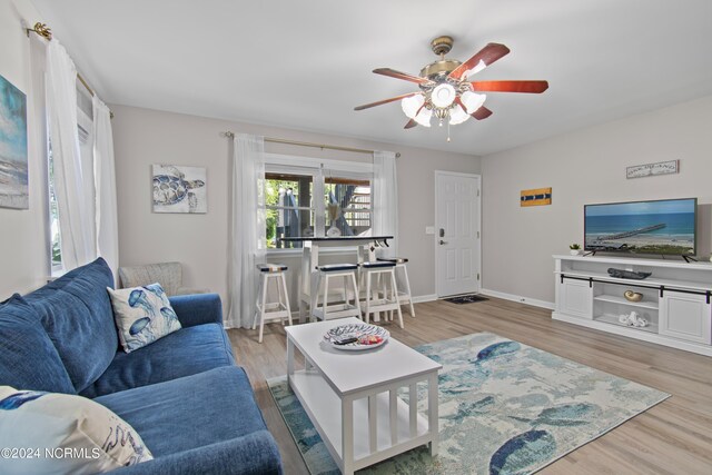 home office with ceiling fan and hardwood / wood-style floors