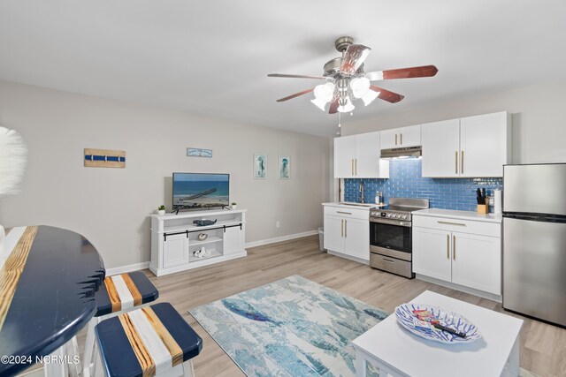 office space featuring ceiling fan and light hardwood / wood-style floors