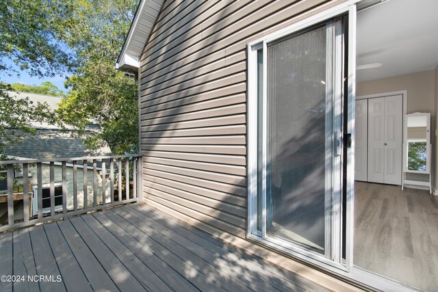 wooden terrace featuring ceiling fan and a porch