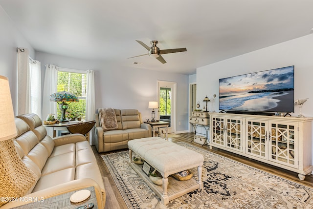 living room with hardwood / wood-style flooring, ceiling fan, and a wealth of natural light