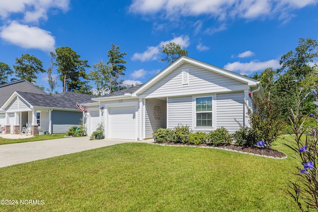 view of front of house with a front lawn and a garage