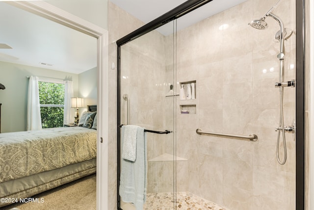 bathroom featuring a shower with shower door