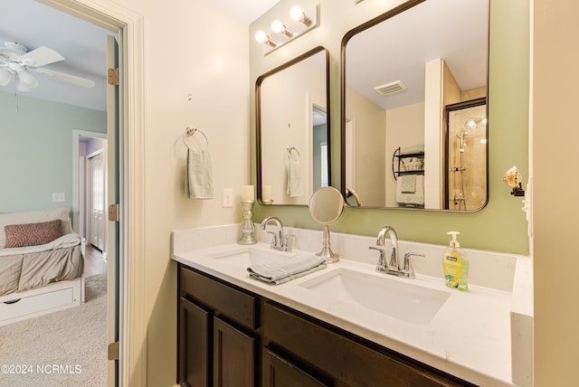 bathroom with vanity, ceiling fan, and a shower with shower door