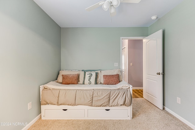 bedroom featuring light carpet and ceiling fan