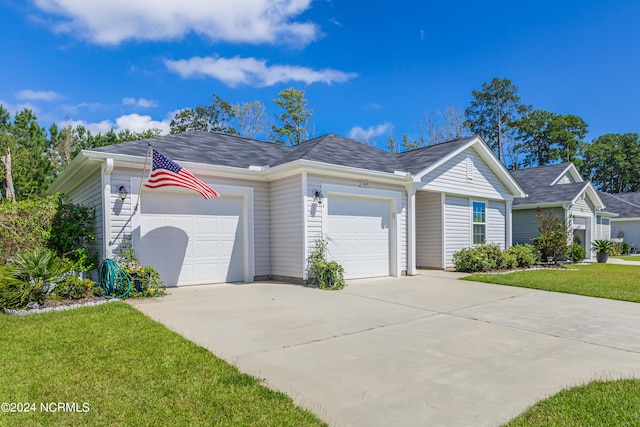 ranch-style house with a garage and a front yard