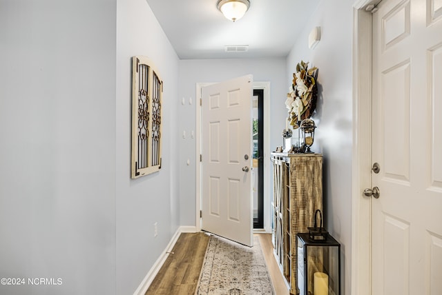 doorway to outside with wood-type flooring