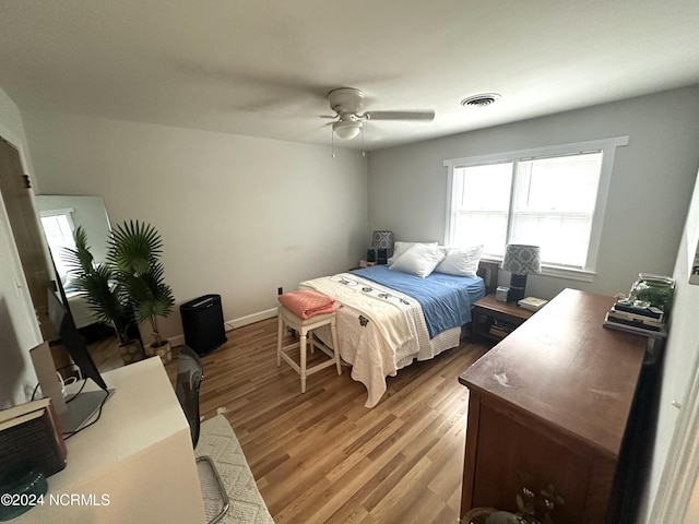 bedroom with ceiling fan and hardwood / wood-style floors