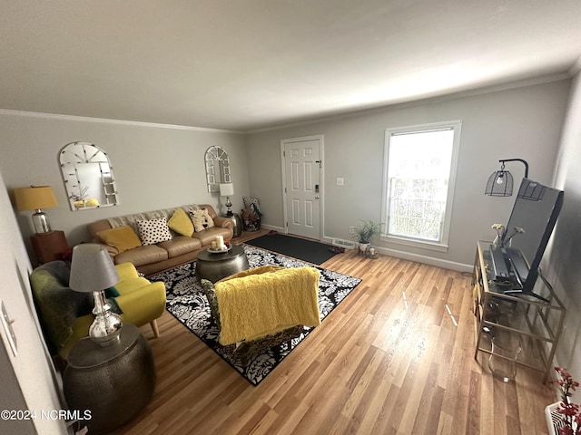 living room with crown molding and hardwood / wood-style floors