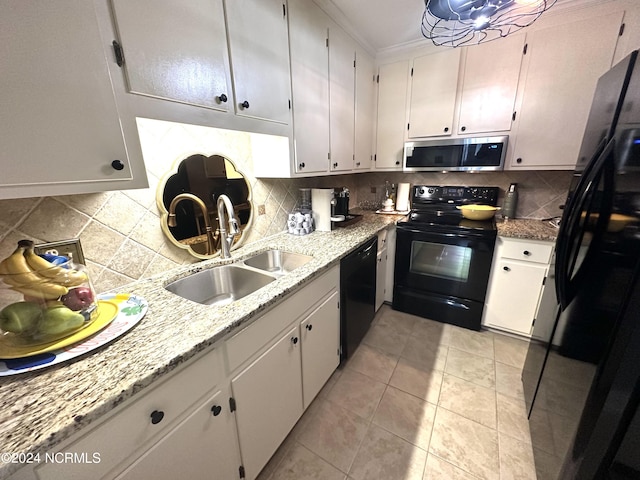 kitchen featuring black appliances, light stone counters, white cabinetry, and sink