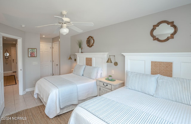 bedroom featuring light tile patterned floors, ceiling fan, and a closet