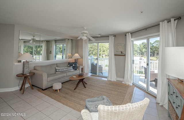 tiled living room featuring ceiling fan and plenty of natural light