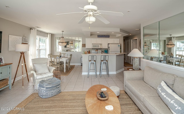 living room with ceiling fan and light tile patterned floors