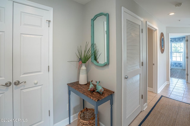 corridor featuring light tile patterned floors