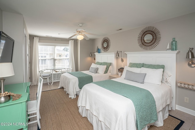 tiled bedroom featuring ceiling fan