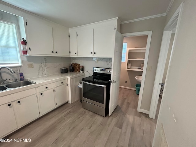 kitchen with light wood-type flooring, sink, white cabinets, electric stove, and crown molding