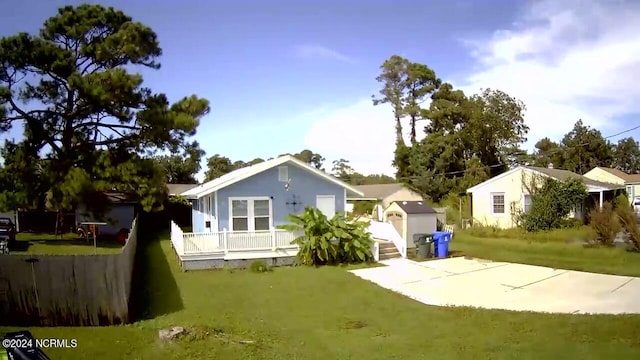 rear view of property featuring a lawn