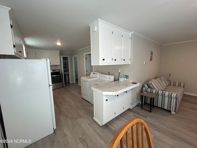 kitchen with white cabinets, white refrigerator, washer and dryer, and kitchen peninsula