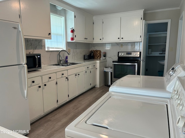 kitchen with stainless steel appliances, white cabinets, light wood-type flooring, and sink