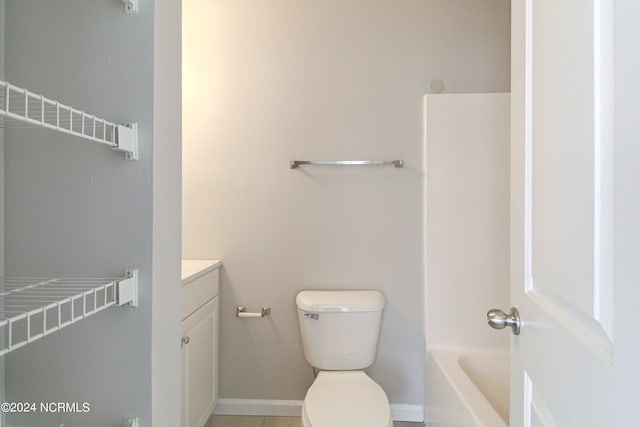 bathroom with vanity, tile patterned flooring, and toilet