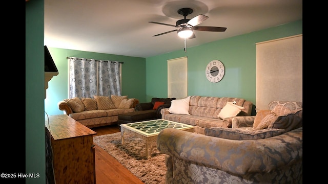 living room with ceiling fan and wood-type flooring