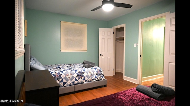 bedroom with ceiling fan and wood-type flooring