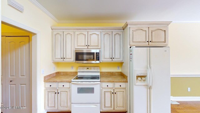 kitchen featuring light hardwood / wood-style flooring, white appliances, and crown molding