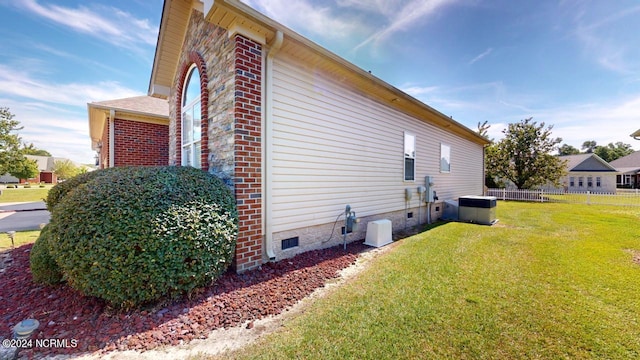 view of side of home featuring a lawn